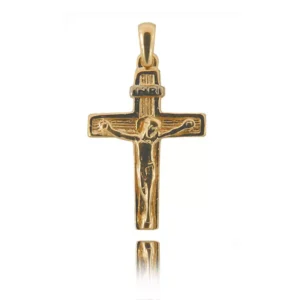 Złoty krzyżyk o symbolicznym znaczeniu.
